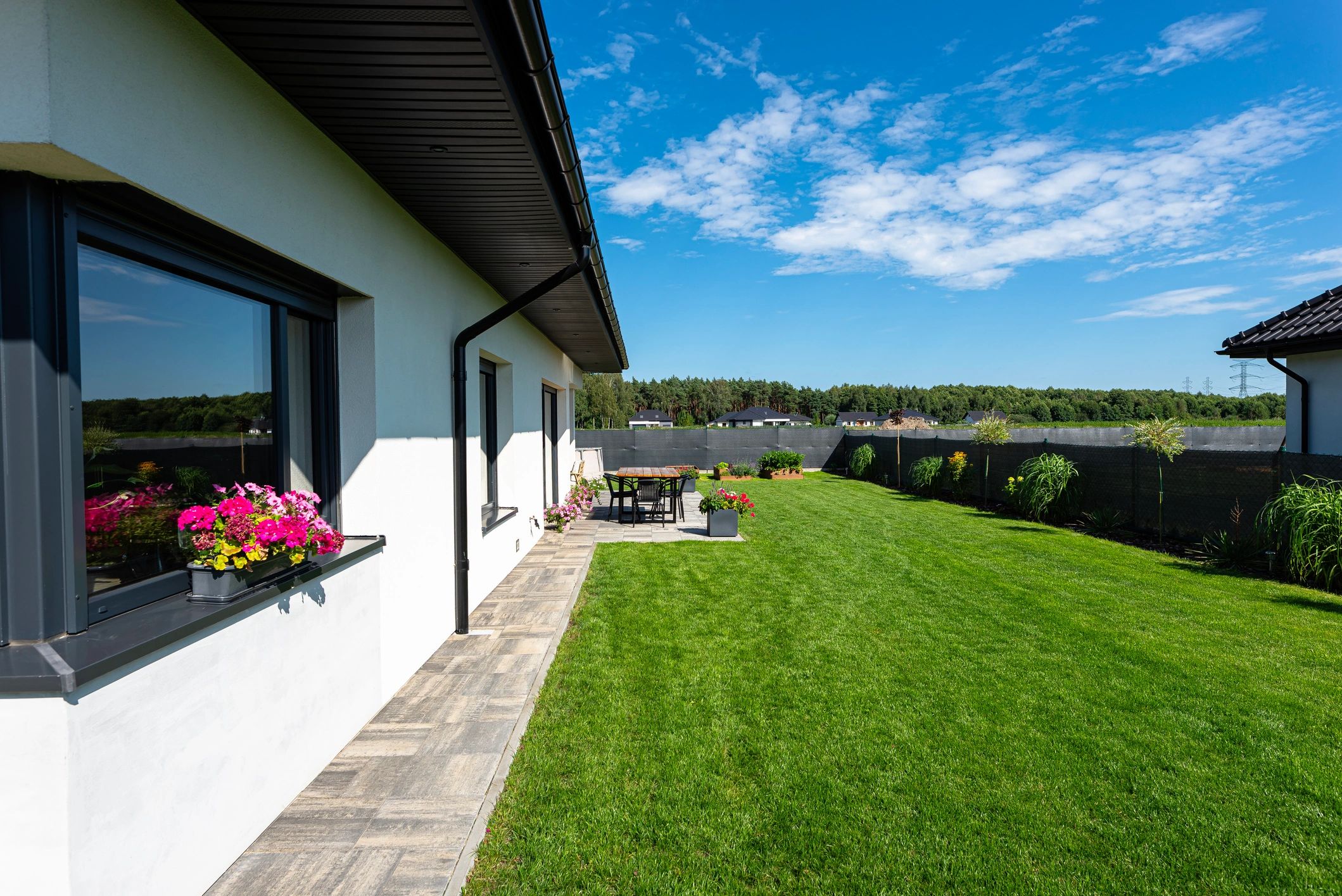 Backyard terrace and landscaped lawn